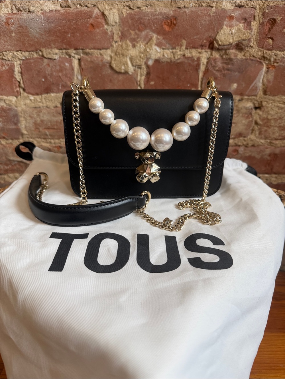 TOUS Black Leather Crossbody with Pearl Accent and Gold Chain